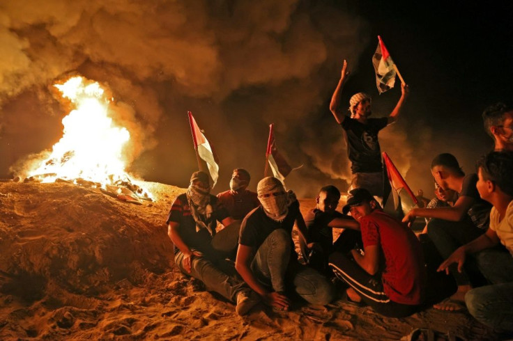 Palestinians gather during a recent night protest along the border fence in the southern Gaza Strip, demanding an end to Israel's blockade