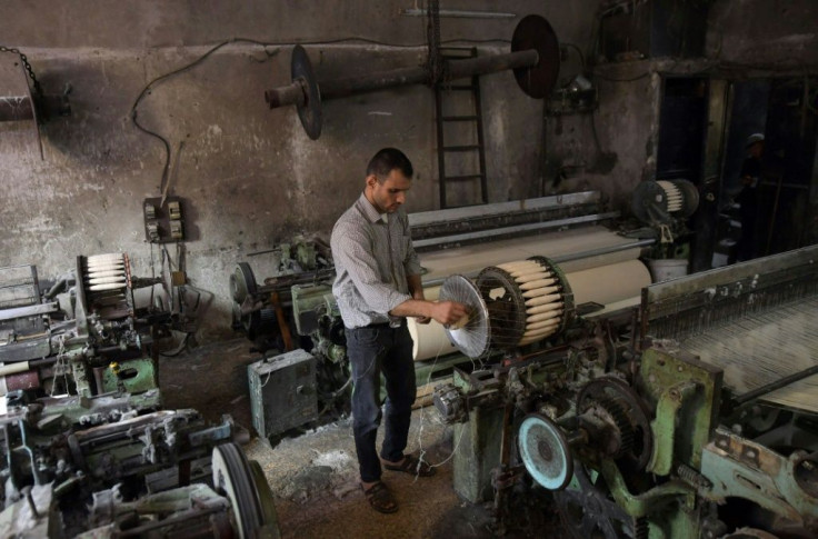 Syrian Mahmud Majkini toils in his workshop in the northern city of Aleppo