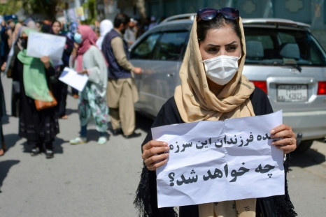An Afghan woman displays a placard during the demonstrations