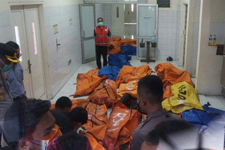 Body bags containing the remains of those killed in the prison fire near Jakarta arrive at a hospital morgue