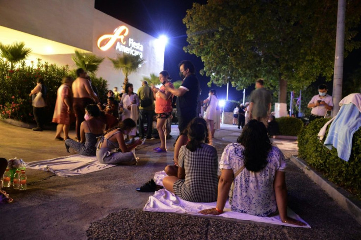 People wait outside a hotel in the Mexican city of Acapulco after a 7.1-magnitude earthquake