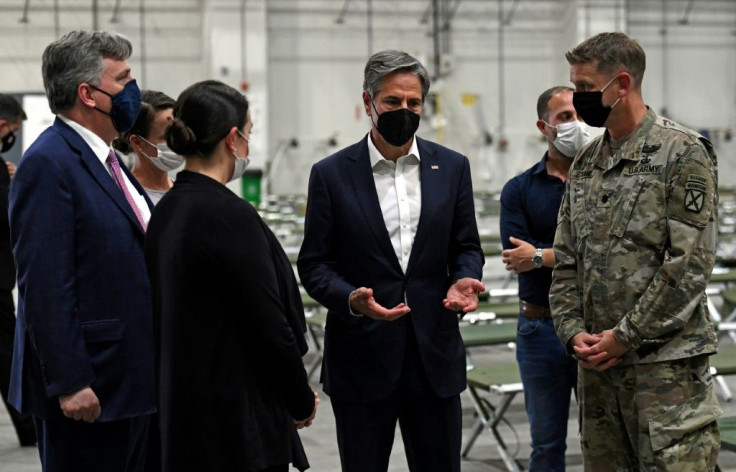 US Secretary of State Antony Blinken (C) tours a processing centre for Afghan refugees at Al-Udeid airbase outside Doha on September 7, 2021