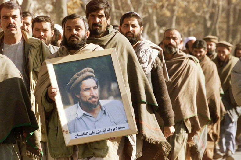 An Afghan man holds a portrait of Ahmad Shah Massoud in December 2001