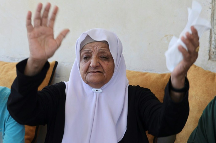 Subhiyeh al-Ardah, the mother of escaped prisoner Mohammad Qassem Ardah, prays for him at her home in Arraba village south of Jenin on September 8, 2021