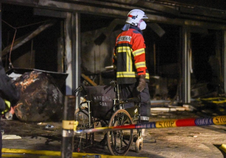 Police and firefighters inspect the scene at a Covid-19 clinic after a fire broke out, in Tetovo, North Macedonia
