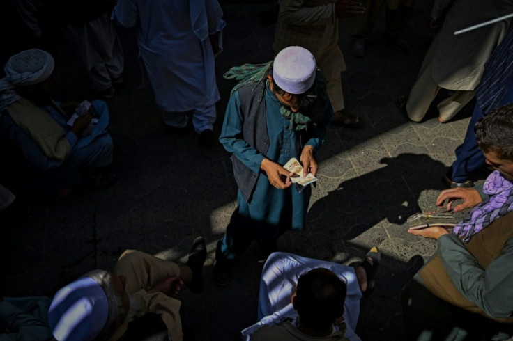A dealer counts cash at Kabul's main forex exchange. The Afghani has taken a hammering since the Taliban returned to power on August 15