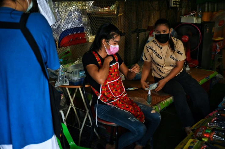 Vendors take sweat-covered testing swabs from under their clothing