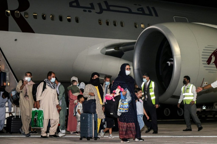 Evacuees from Afghanistan arrive at Hamad International Airport in Qatar's capital Doha on the first flight carrying foreigners out of the Afghan capital since the conclusion of the US withdrawal last month