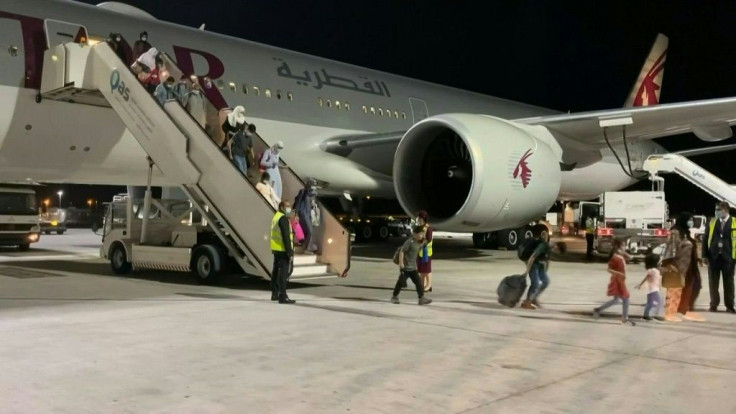 IMAGES Passengers onboard a Qatar Airways plane from Kabul disembark at Hamad International Airport in Doha, the first flight out of the Afghan capital since a US-led evacuation ended on August 30.