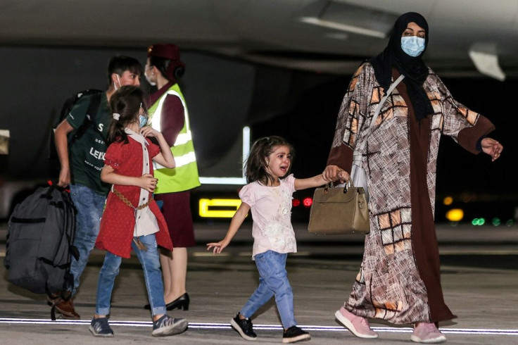 Evacuees from Afghanistan arrive at Hamad International Airport in Qatar's capital Doha on the first flight carrying foreigners out of Kabul since last month's US withdrawal