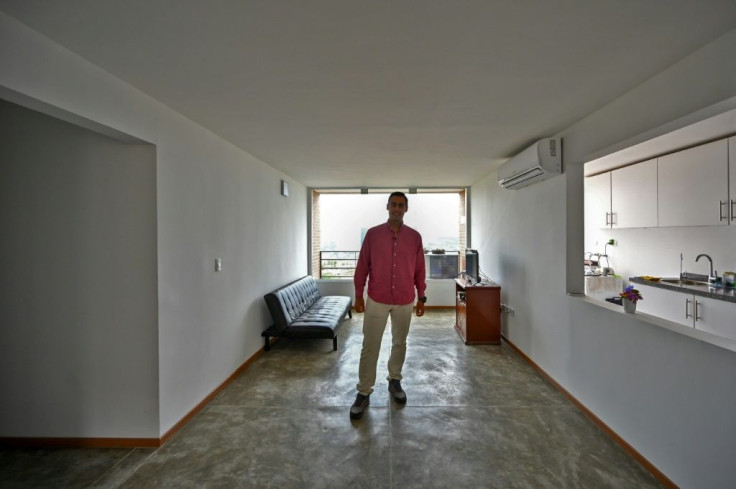 Gustavo Martinez rents an apartment in Caracas with his girlfriend, unable to get a loan to buy his own place despite earning a good salary