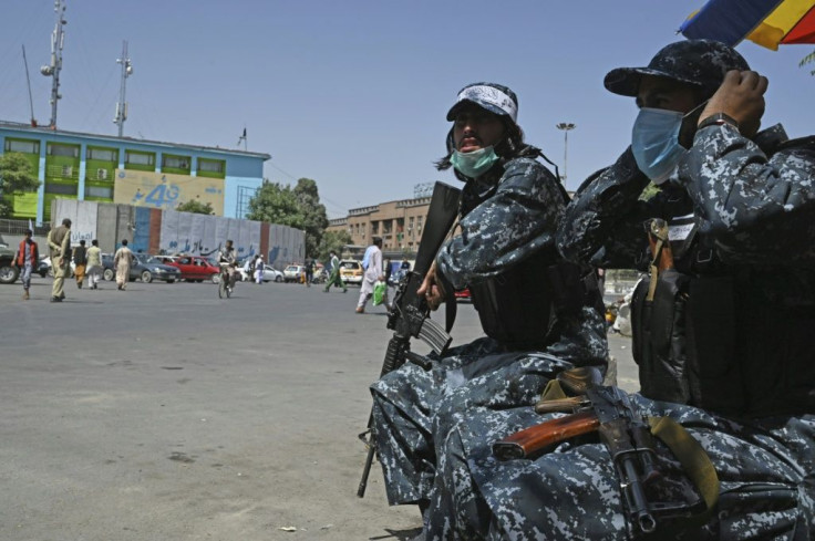 Taliban fighters stand guard along a street in Kabul on September 9, 2021, as Afghanistan faces an economic crisis with its access to cash and aid cut off