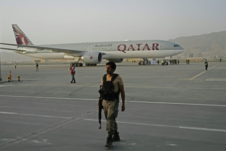 A Qatari security officer stood guard as evacuees boarded the Qatar Airways aircraft bound for Doha at the airport in the Afghan capital Kabul on September 10, 2021