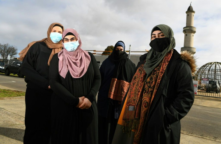 Rayan Saaad (L), Isra Taleb (2/L), Rukaya Taleb (2/R) and Sema Bolat (R) call members of their local community providing them with help during Melbourne's coronavirus lockdown