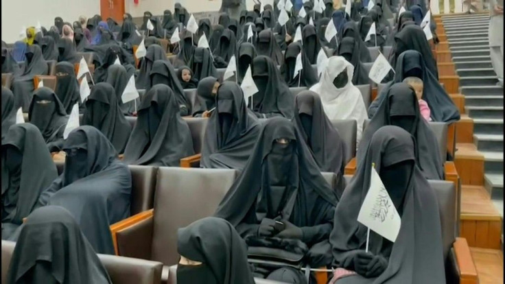 SOUNDBITE About 300 Afghan women, fully covered in attire deemed acceptable to the Taliban and holding their white-and-black flags, gather at a Kabul university in a show of support for the Islamists. The display comes as the Taliban move to snuff out civ