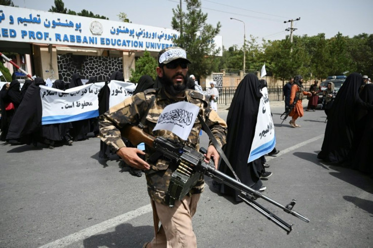 An armed Taliban fighter escorted the women as they rallied in favour of the new Islamist regime