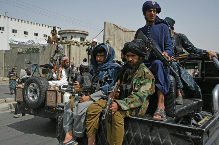 Taliban fighters escorted veiled women marching during a pro-Taliban rally