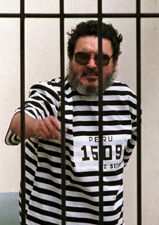 This file photo taken on September 24, 1992, shows Abimael Guzman, the captured leader of the radical group Shining Path, behind bars in Lima, Peru
