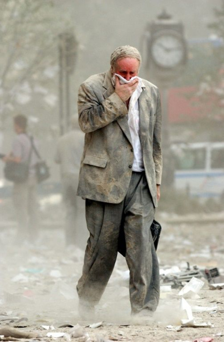 This file photo taken on September 11, 2001, shows Edward Fine covering his mouth as he walks through dust and debris following the collapse of one of the twin towers of the World Trade Center