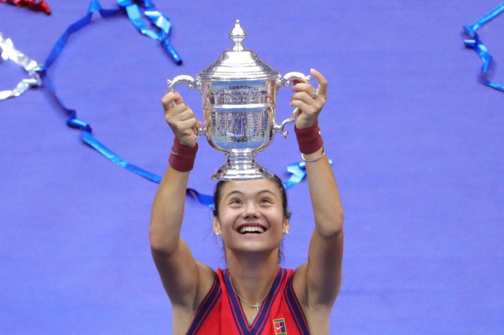 Britain's Emma Raducanu celebrates with the US Open championship trophy after beating Canada's Leylah Fernandez in Saturday's final