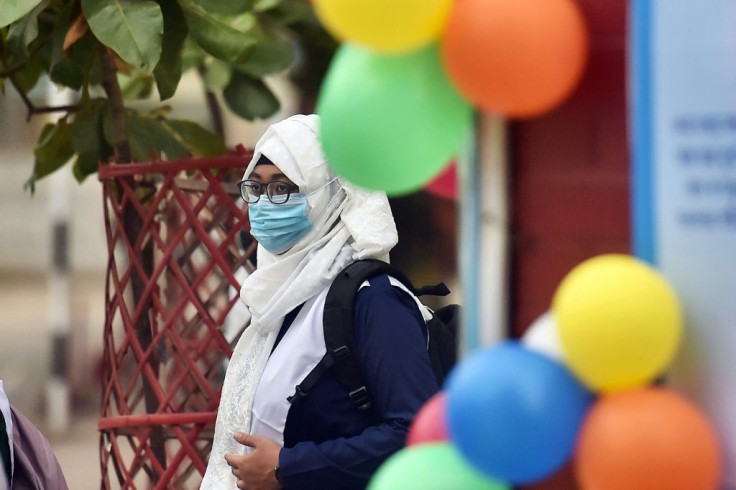 One school in Dhaka welcomed students with flowers and sweets, and asked them to wear masks and sanitise their hands