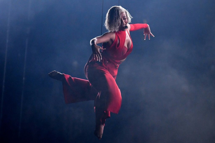 Doja Cat took a break from hosting duties for an aerial performance in a sultry red get-up