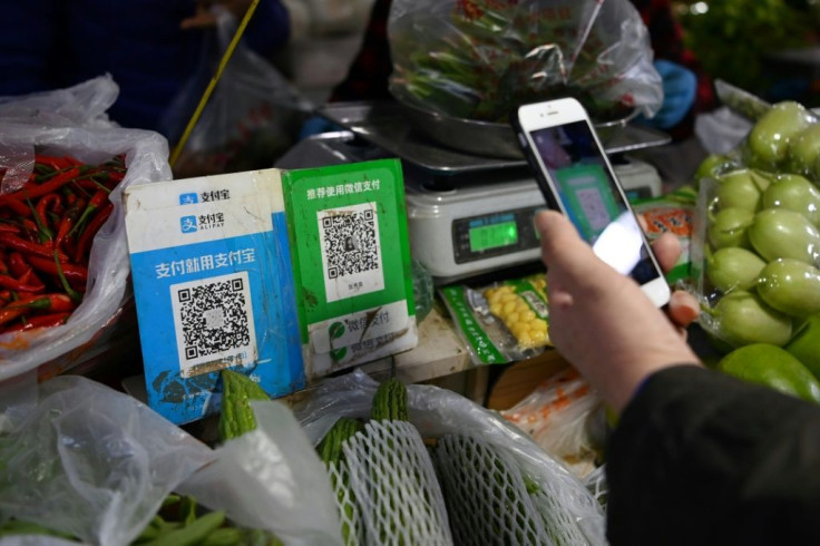 Alipay's app (QR code L) currently allows users to pay with a traditional credit card linked to their bank or offers small unsecured loans to buy anything from toilet paper to laptops