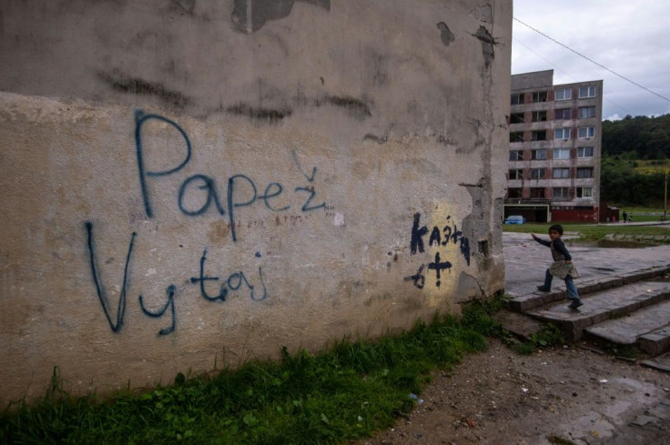 Graffitti on a wall in the Lunik IX estate reads 'Welcome Pope'