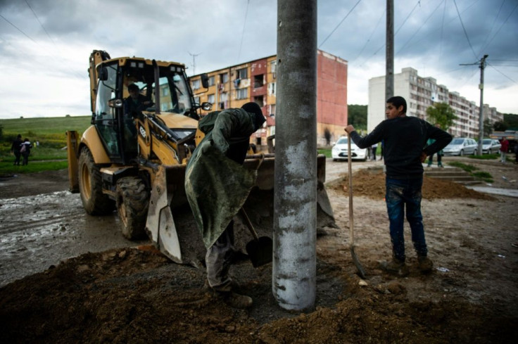 Workers install new street lights in the Lunik IX district ahead of the papal visit