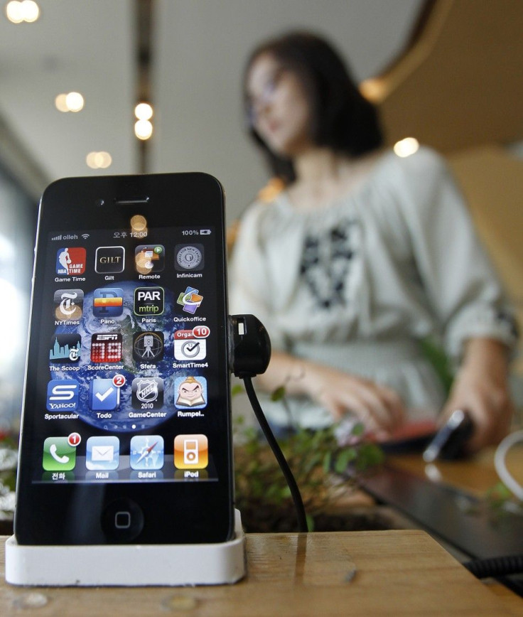 An Apple iPhone 4 smartphone displayed for visitors at a registration desk at KT's headquarters in Seoul