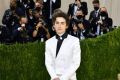 US-French actor Timothee Chalamet, wearing a white suit and sneakers, arrives for the 2021 Met Gala at the Metropolitan Museum of Art on September 13, 2021 in New York