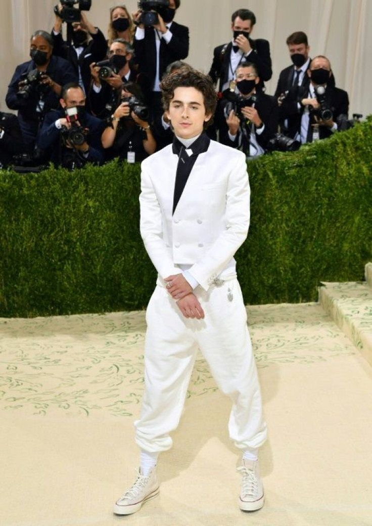 US-French actor Timothee Chalamet, wearing a white suit and sneakers, arrives for the 2021 Met Gala at the Metropolitan Museum of Art on September 13, 2021 in New York