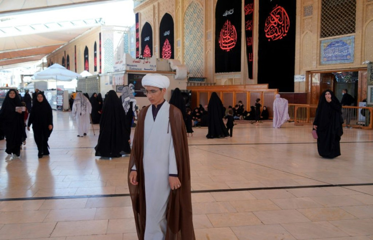 Sheikh Qorban Ali, seen here walking in the Imam Ali shrine in Iraq's central holy shrine city of Najaf, dreams of going home to Afghanistan