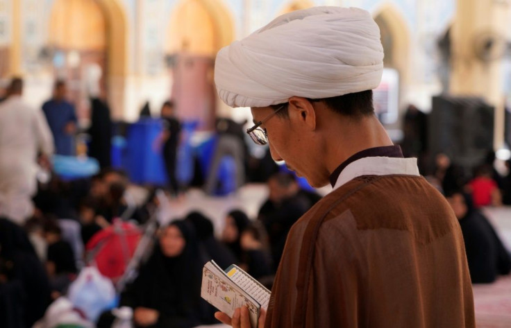 Sheikh Qorban Ali reads at the Imam Ali shrine in Iraq's central holy shrine city of Najaf
