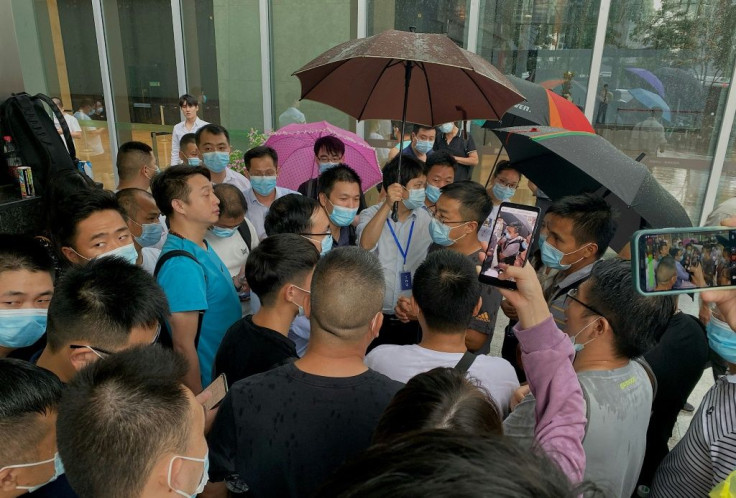 Dozens of anxious protesters gathered outside Chinese conglomerate Evergrande's headquarters in Shenzhen