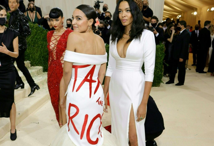 Democratic House Representative Alexandria Ocasio-Cortez (L) raised eyebrows when she wore a dress declaring "Tax the Rich" at the Met Gala in New York on September 13, 2021