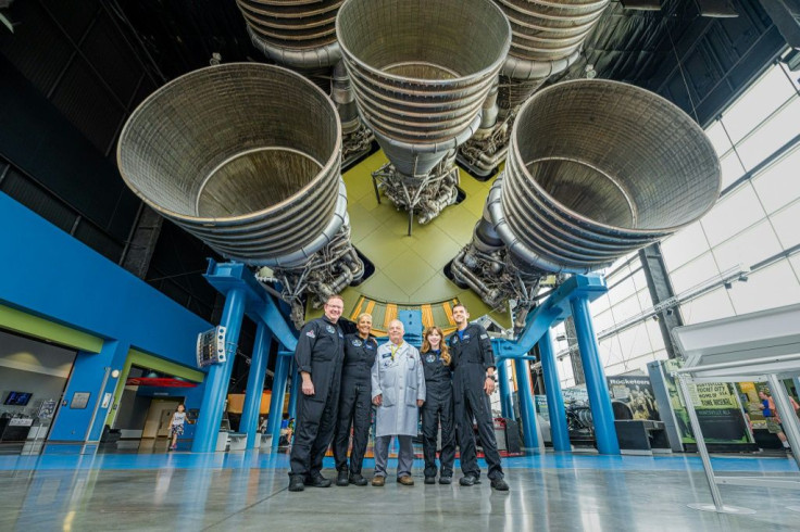 The Inspiration4 crew (L-R) Chris Sembroski, Sian Proctor, Hayley Arceneaux and Jared Isaacman, posing with a technician (C) in Huntsville, Alabama