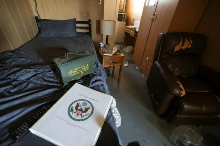 A folder with a US army insignia is seen next to an ammunition box in a room inside a room at Kabul airport