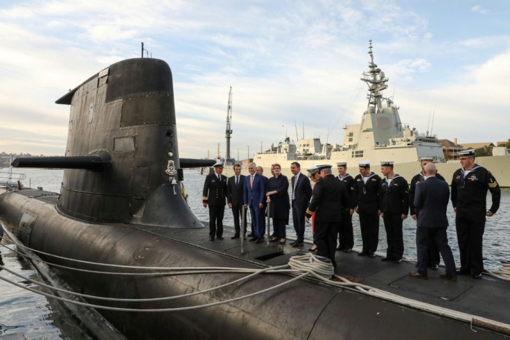 French President Emmanuel Macron (2nd L) and former Australian prime minister Malcolm Turnbull (3rd L) stand on the deck of a Collins-class submarine in Sydney in May 2018 -- reports say that an expected security deal with the United States and Britain co