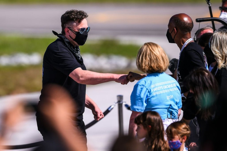 SpaceX CEO Elon Musk (L) meets with family members during the Inspiration4 crew send off at NASAâs Kennedy Space Center in Florida