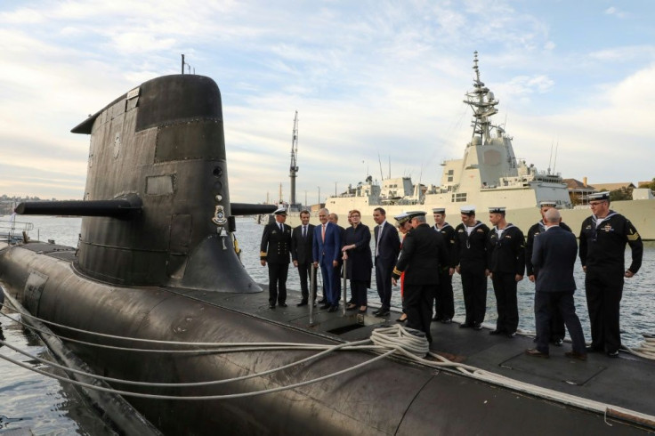 French President Emmanuel Macron (2nd L) and former Australian prime minister Malcolm Turnbull (3rd L) stand on the deck of a Collins-class submarine in Sydney in May 2018 -- the new security deal with the United States and Britain could derail Australia'