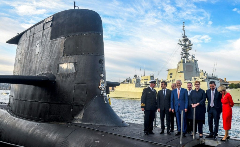 French President Emmanuel Macron and Australian Prime Minister Malcolm Turnbull stand on the deck of HMAS Waller, a Collins-class submarine operated by the Royal Australian Navy, in Sydney in May 2018 as France fulfilled a submarine deal