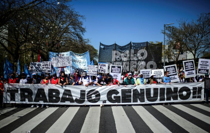 Protesters rally against Argentine President Alberto Fernandez behind a banner reading âGenuine Work!â at 9 de Julio avenue, in Buenos Aires, on September 16, 2021