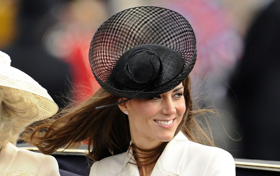 Britain039s Catherine, Duchess of Cambridge smiles as she rides to Buckingham Palace after attending the Trooping the Colour ceremony in central London