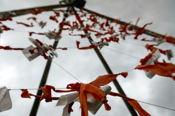 Notes and orange knots hang on a wooden tipi at the entrance of Pikogan, Quebec on September 9, 2021, a reminder of the unmarked graves in residential schools in Canada -- a history candidate Lise Kistabish hopes the country will not forget