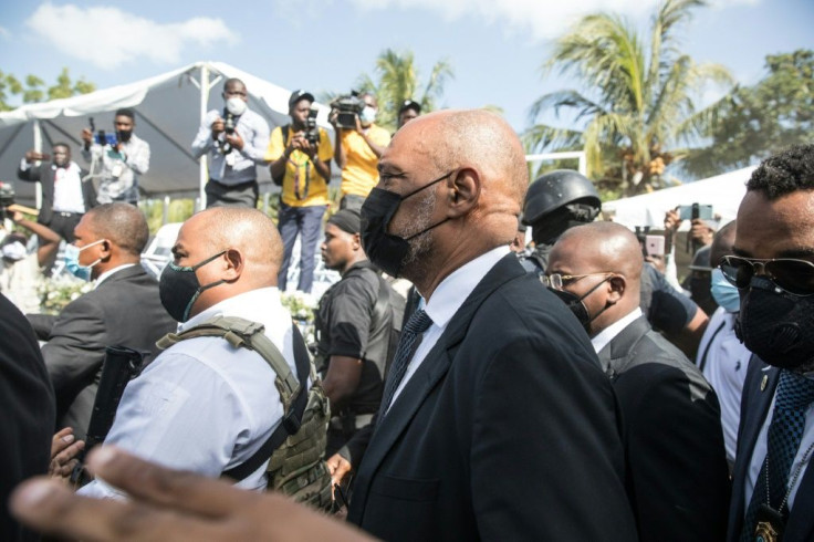 Haiti's Prime Minister Ariel Henry (C), seen here attending the funeral of slain President Jovenel MoÃ¯se on July 23, 2021, in Cap-Haitien, Haiti, fired a prosecutor who accused him of links to the killing
