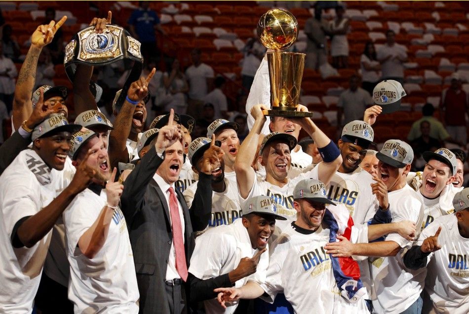 Dallas Mavericks039 Jason Kidd raises the Larry O039Brien Championship Trophy surrounded by his teammates after the Mavericks beat the Miami Heat in Game 6 to win the NBA Finals basketball series in Miami.