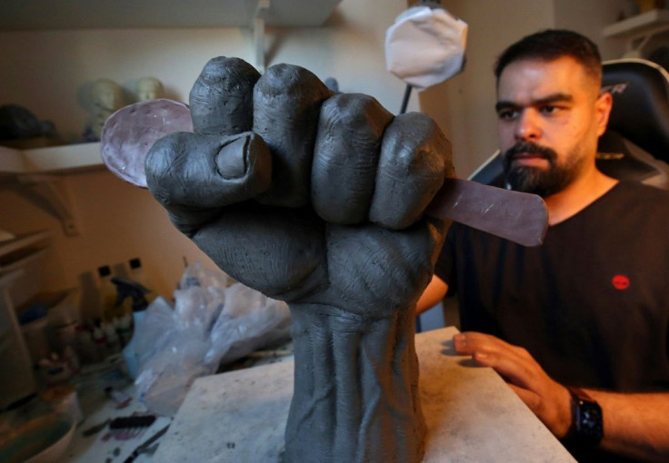 Kuwaiti artist Maitham Abdal works on his sculpture, "Spoon of Freedom", at his home workshop in Kuwait City