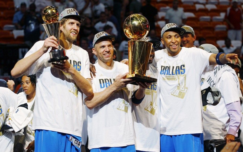 Mavericks039 Nowitzki holds the Bill Russell NBA Finals MVP trophy as Kidd holds the Larry O039Brien Championship Trophy with Marion after their team defeated the Heat to win the NBA Finals basketball series in Miami