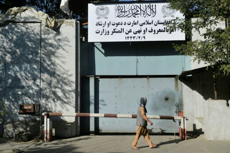 Workers put up a sign for the notorious Ministry for the Promotion of Virtue and Prevention of Vice at the old Women's Affairs building in Kabul